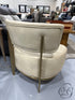 Tan Armless Chair With Gold Metal Legs
